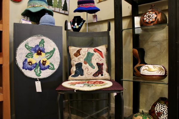 Pieces of Cheryl Roberts, a fiber artist out of Creston, North Carolina, are displayed in the Hands Gallery as of Jan. 23. Roberts makes a wide variety of fiber items involving rug hooking, spinning, dyeing and knitting, and is also a certified McGown Teacher.