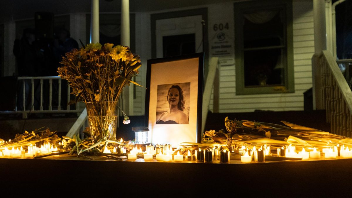 A photo of Renee Nicole Good sits atop a coffin lined with candles and flowers at the Jones House Cultural Center on Jan. 9.