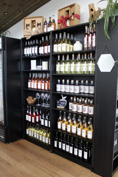 The stock shelf of various wines and ciders available at Mill Camp Wines & Ciders as of Feb. 21. They make all their products in the cellar beneath the main entrance and lobby of the building.