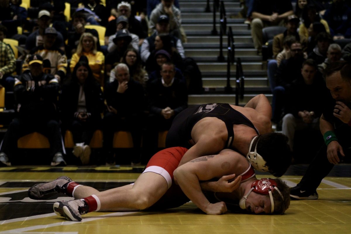 165-pound redshirt junior Anthony Conetta holding his Gardner-Webb University opponent in a pin during his match on Feb. 22. Conetta went on to win this match by technical fall at 18-2. 