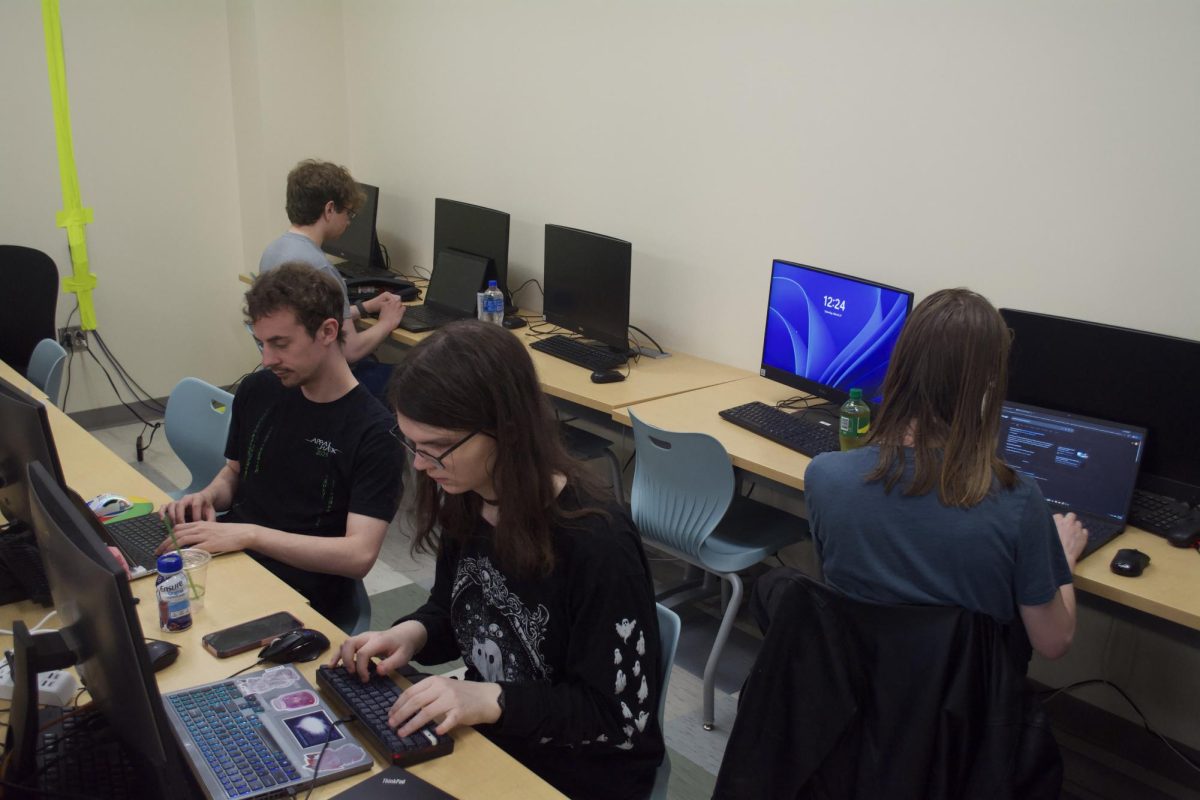 A team of coders works diligently to make sure their project is finished at the Hackathon on March 21.