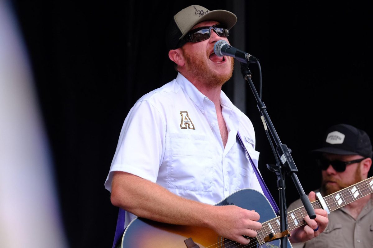 Country singer Adam Church sings his song “Smokin’ My Daze Away” on the ECRS Stage at Boonerang on June 21. Church is an App State alumni and regular act around the High Country.