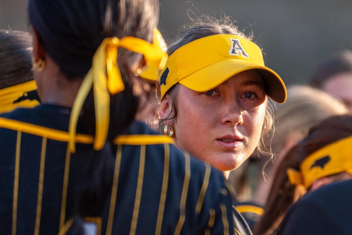 Senior infielder Makayla McClain celebrates with teammates at Sywassink/Lloyd Family Stadium April 7. 